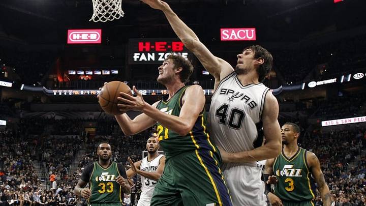 Jan 6, 2016; San Antonio, TX, USA; Utah Jazz center Tibor Pleiss (21) shoots the ball as San Antonio Spurs center Boban Marjanovic (40) defends during the first half at AT&T Center. Mandatory Credit: Soobum Im-USA TODAY Sports