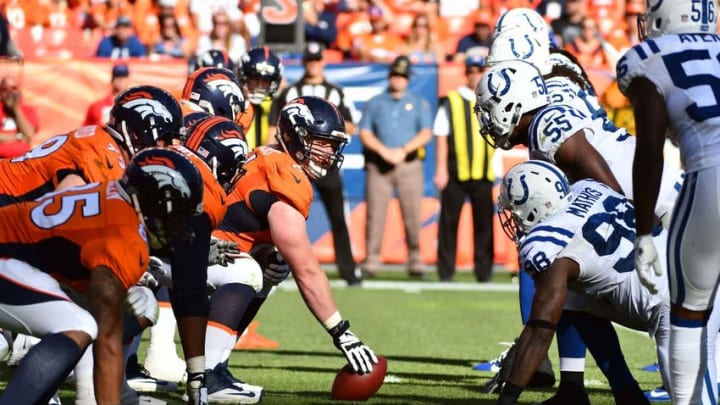 Sep 18, 2016; Denver, CO, USA; Denver Broncos center Matt Paradis (61) prepares to hike the ball across from Indianapolis Colts outside linebacker Robert Mathis (98) and inside linebacker Sio Moore (55) in the second half at Sports Authority Field at Mile High.The Broncos defeated the Colts 34-20. Mandatory Credit: Ron Chenoy-USA TODAY Sports