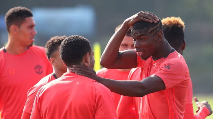 MANCHESTER, ENGLAND - SEPTEMBER 14: Paul Pogba of Manchester United chats to his team-mates during a Manchester United training session at Aon Training Complex on September 14, 2016 in Manchester, England. (Photo by Matthew Peters/Man Utd via Getty Images)