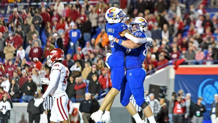 MEMPHIS, TENNESSEE – DECEMBER 28: Mason Fairchild #89 and Lawrence Arnold #2 of the Kansas Jayhawks celebrate during the first half of the AutoZone Liberty Bowl game against the Arkansas Razorbacks at Simmons Bank Liberty Stadium on December 28, 2022 in Memphis, Tennessee. (Photo by Justin Ford/Getty Images)