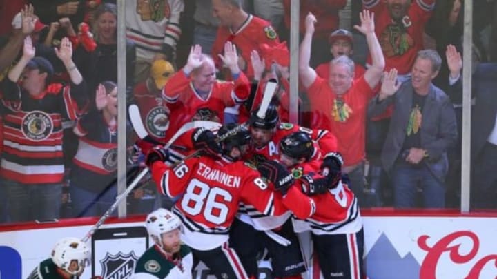 May 3, 2015; Chicago, IL, USA; Chicago Blackhawks left wing Patrick Sharp (center) is congratulated for scoring a goal by left wing Teuvo Teravainen (left) and center Antoine Vermette (right) during the third period in game two of the second round of the 2015 Stanley Cup Playoffs against the Minnesota Wild at the United Center. Chicago won 4-1. Mandatory Credit: Dennis Wierzbicki-USA TODAY Sports