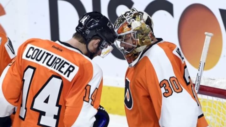 Jan 5, 2016; Philadelphia, PA, USA; Philadelphia Flyers center Sean Couturier (14) and goalie Michal Neuvirth (30) celebrate win against the Montreal Canadiens at Wells Fargo Center. The Flyers defeated the Canadiens, 4-3. Mandatory Credit: Eric Hartline-USA TODAY Sports