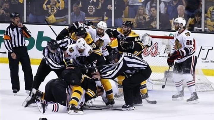 Jun 17, 2013; Boston, MA, USA; The officials try to break up a fight between Boston Bruins defenseman Zdeno Chara (33) and Chicago Blackhawks left wing Bryan Bickell (29) during the third period in game three of the 2013 Stanley Cup Final at TD Garden. The Bruins won 2-0. Mandatory Credit: Greg M. Cooper-USA TODAY Sports