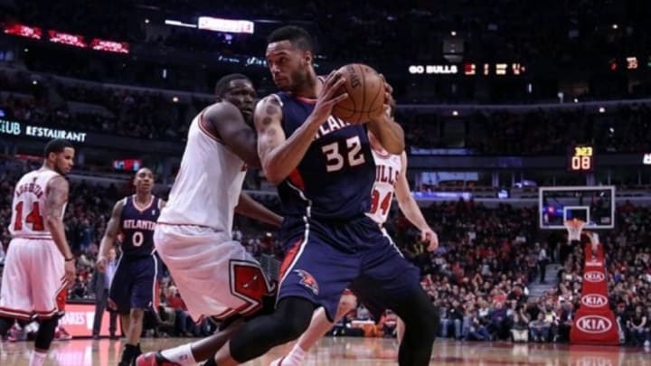 Jan 4, 2014; Chicago, IL, USA; Atlanta Hawks power forward Mike Scott (32) is defended by Chicago Bulls small forward Luol Deng (9) during the second quarter at the United Center. Mandatory Credit: Dennis Wierzbicki-USA TODAY Sports