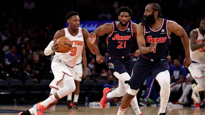 NEW YORK, NEW YORK - FEBRUARY 27: RJ Barrett #9 of the New York Knicks drives to the basket past Joel Embiid #21 of the Philadelphia 76ers and James Harden #1 of the Philadelphia 76ers during the second half at Madison Square Garden on February 27, 2022 in New York City. Philadelphia 76ers won 125-109. NOTE TO USER: User expressly acknowledges and agrees that, by downloading and or using this Photograph, user is consenting to the terms and conditions of the Getty Images License Agreement. (Photo by Adam Hunger/Getty Images)