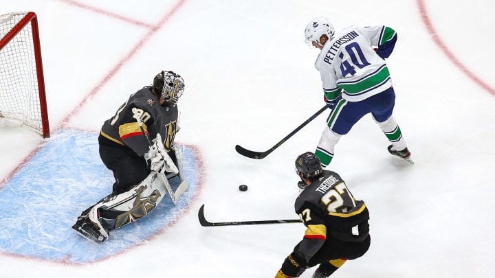 Elias Pettersson of the Vancouver Canucks attempts a shot on Robin Lehner (Photo by Bruce Bennett/Getty Images)