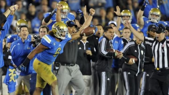 November 22, 2014; Pasadena, CA, USA; UCLA Bruins linebacker Eric Kendricks (6) celebrates after intercepting a pass against the Southern California Trojans during the first half at the Rose Bowl. Mandatory Credit: Gary A. Vasquez-USA TODAY Sports