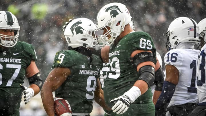 EAST LANSING, MICHIGAN - NOVEMBER 27: Kenneth Walker III #9 and Blake Bueter #69 of the Michigan State Spartans celebrate after Walker III scored a touchdown during the first quarter at Spartan Stadium on November 27, 2021 in East Lansing, Michigan. (Photo by Nic Antaya/Getty Images)