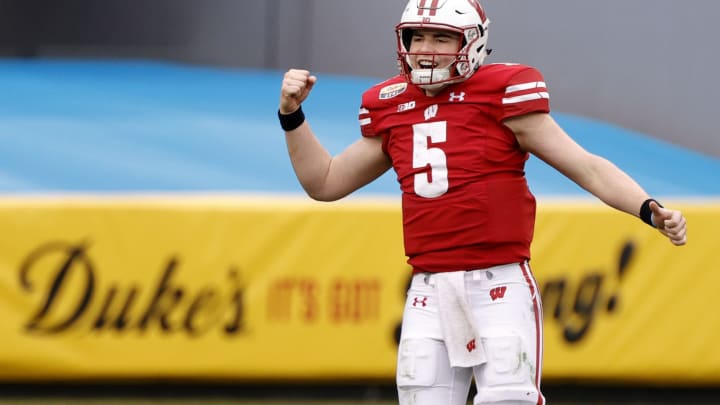 CHARLOTTE, NORTH CAROLINA – DECEMBER 30: Quarterback Graham Mertz #5 of the Wisconsin Badgers celebrates following a touchdown drive against the Wake Forest Demon Deacons during the fourth quarter of the Duke’s Mayo Bowl at Bank of America Stadium on December 30, 2020, in Charlotte, North Carolina. (Photo by Jared C. Tilton/Getty Images)