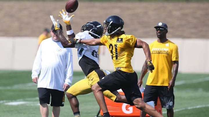 Jul 29, 2016; Latrobe, PA, USA; Pittsburgh Steelers wide receiver Antonio Brown (left) attempts a pass reception as Pittsburgh Steelers defensive back Ross Cockrell (31) defends during training camp at Saint Vincent College. Mandatory Credit: Charles LeClaire-USA TODAY Sports