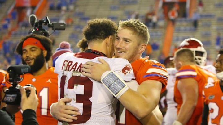Nov 14, 2020; Gainesville, FL, USA; Florida quarterback Kyle Trask (11) hugs his former teammate Arkansas quarterback Feleipe Franks (13) after the Gators win over the Razorbacks in a football game at Ben Hill Griffin Stadium. Mandatory Credit: Brad McClenny-USA TODAY NETWORK