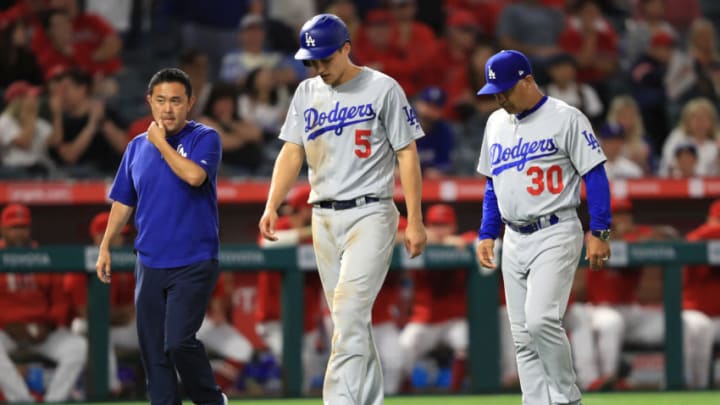 ANAHEIM, CALIFORNIA - JUNE 11: Manager Dave Roberts and team trainer walk Corey Seager #5 of the Los Angeles Dodgers off the field after he was injured rounding third base during the ninth inning of a game against the Los Angeles Dodgers at Angel Stadium of Anaheim on June 11, 2019 in Anaheim, California. (Photo by Sean M. Haffey/Getty Images)