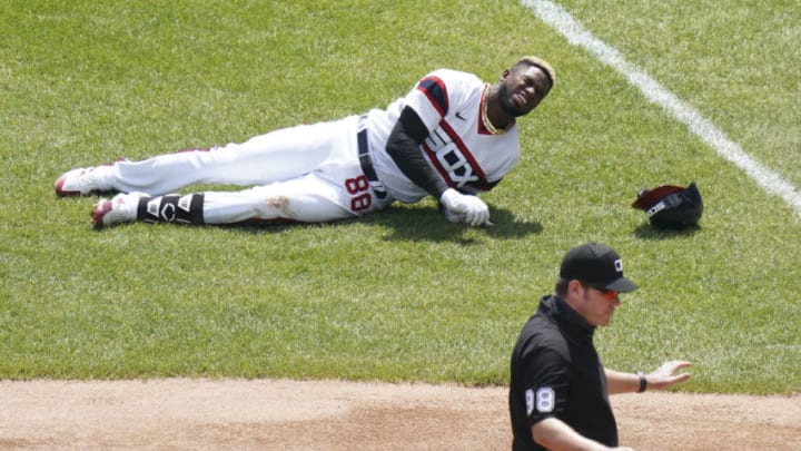 CHICAGO, ILLINOIS - MAY 02: Luis Robert #88 of the Chicago White Sox gets injured after reaching first base on a single during the first inning of a game against the Cleveland Indians at Guaranteed Rate Field on May 02, 2021 in Chicago, Illinois. (Photo by Nuccio DiNuzzo/Getty Images)