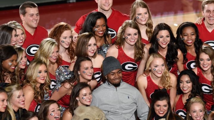 Feb 6, 2016; Athens, GA, USA; Injured Southern University football player Devon Gales (C) poses with the Georgia Bulldogs cheerleaders after the Bulldogs defeated the Auburn Tigers 65-55 at Stegeman Coliseum. Mandatory Credit: Dale Zanine-USA TODAY Sports