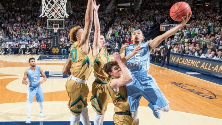 Feb 6, 2016; South Bend, IN, USA; North Carolina Tar Heels guard Marcus Paige (5) goes up for a shot as Notre Dame Fighting Irish forward Zach Auguste (30) guard Rex Pflueger (0) and guard Steve Vasturia (32) defend in the second half at the Purcell Pavilion. Notre Dame won 80-76. Mandatory Credit: Matt Cashore-USA TODAY Sports