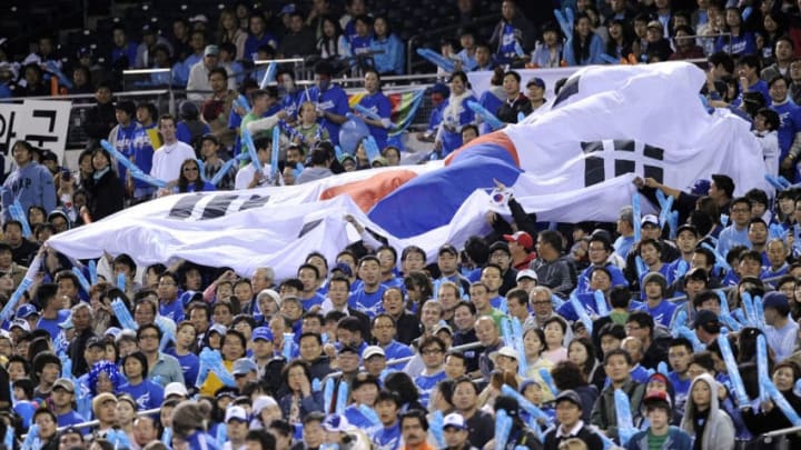 SAN DIEGO - MARCH 17: A Korean flag gets passed down through the stands as Korea plays against Japan during the 2009 World Baseball Classic Round 2 Pool 1 Game 4 on March 17, 2009 at Petco Park in San Diego, California. (Photo by Kevork Djansezian/Getty Images)