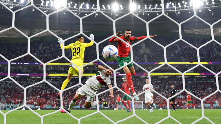 DOHA, QATAR – DECEMBER 10: (EDITORS NOTE: In this photo taken from a remote camera from behind the goal) Youssef En-Nesyri of Morocco heads to score the team’s first goal during the FIFA World Cup Qatar 2022 quarter final match between Morocco and Portugal at Al Thumama Stadium on December 10, 2022 in Doha, Qatar. (Photo by Justin Setterfield/Getty Images)