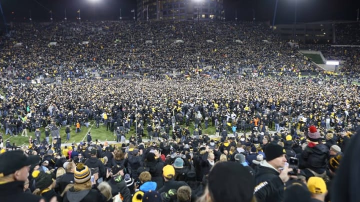 Nov 12, 2016; Iowa City, IA, USA; Fans storm the field after Iowa Hawkeyes place kicker Keith Duncan (not pictured) kicks the game winning field goal against the Michigan Wolverines at Kinnick Stadium. The Hawkeyes won 14-13. Mandatory Credit: Reese Strickland-USA TODAY Sports