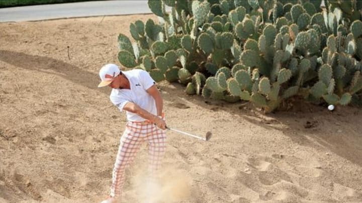 Feb 23, 2014; Marana, AZ, USA; Rickie Fowler plays from the desert on the 14th hole during the semifinal round of the World Golf Championships – Accenture Match Play Championship at The Golf Club at Dove Mountain. Mandatory Credit: Allan Henry-USA TODAY Sports