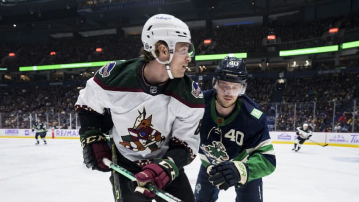 Dec 3, 2022; Vancouver, British Columbia, CAN; Vancouver Canucks forward Elias Pettersson (40) battles with Arizona Coyotes defenseman Jakob Chychrun (6) in the second period at Rogers Arena. Mandatory Credit: Bob Frid-USA TODAY Sports