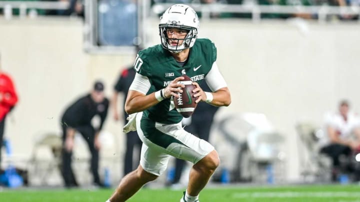 Michigan State’s Payton Thorne rolls out on a pass play against Western Kentucky during the third quarter on Saturday, Oct. 2, 2021, at Spartan Stadium in East Lansing.211002 Msu Wku Fb 177a