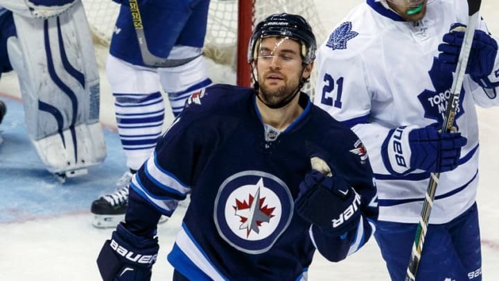 Jan 3, 2015; Winnipeg, Manitoba, CAN; Winnipeg Jets forward T.J. Galiardi (21) celebrates his goal against the Toronto Maple Leafs in the second period at MTS Centre. Mandatory Credit: Shawn Coates-USA TODAY Sports