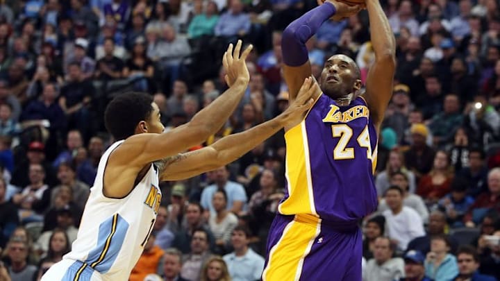 Dec 22, 2015; Denver, CO, USA; Los Angeles Lakers forward Kobe Bryant (24) shoots the ball against Denver Nuggets guard Gary Harris (14) during the second half at Pepsi Center. The Lakers won 111-107. Mandatory Credit: Chris Humphreys-USA TODAY Sports