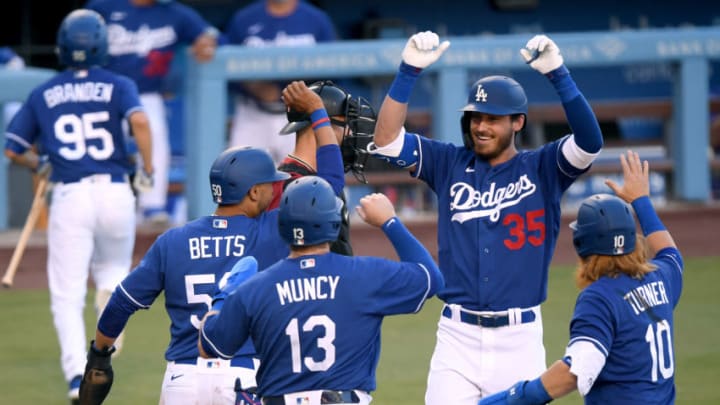 LOS ANGELES, CALIFORNIA - JULY 19: Cody Bellinger #35 of the Los Angeles Dodgers celebrates his grand slam homerun with Mookie Betts #50, Max Muncy #13 and Justin Turner #10 to take a 4-1 lead over the Arizona Diamondbacks in a preseason game during the coronavirus (COVID-19) pandemic at Dodger Stadium on July 19, 2020 in Los Angeles, California. (Photo by Harry How/Getty Images)