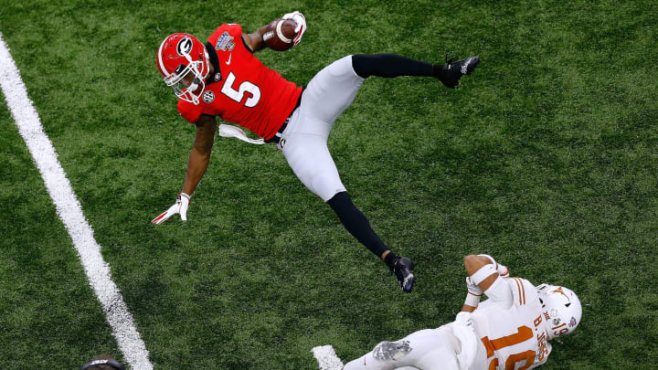NEW ORLEANS, LOUISIANA – JANUARY 01: Terry Godwin #5 of the Georgia Bulldogs is tackled by Brandon Jones #19 of the Texas Longhorns during the first half of the Allstate Sugar Bowl at the Mercedes-Benz Superdome on January 01, 2019 in New Orleans, Louisiana. (Photo by Jonathan Bachman/Getty Images)