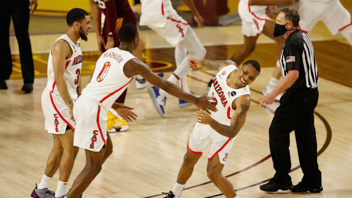 TEMPE, ARIZONA - JANUARY 21: (R-L) James Akinjo #13, Bennedict Mathurin #0 and Jemarl Baker Jr. #3 of the Arizona Wildcats celebrate after defeating the Arizona State Sun Devils in the NCAAB game at Desert Financial Arena on January 21, 2021 in Tempe, Arizona. The Wildcats defeated the Sun Devils 84-82. (Photo by Christian Petersen/Getty Images)