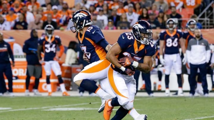 Oct 24, 2016; Denver, CO, USA; Denver Broncos quarterback Trevor Siemian (13) hands the ball off to running back Devontae Booker (23) in the second quarter against the Houston Texans at Sports Authority Field at Mile High. Mandatory Credit: Isaiah J. Downing-USA TODAY Sports