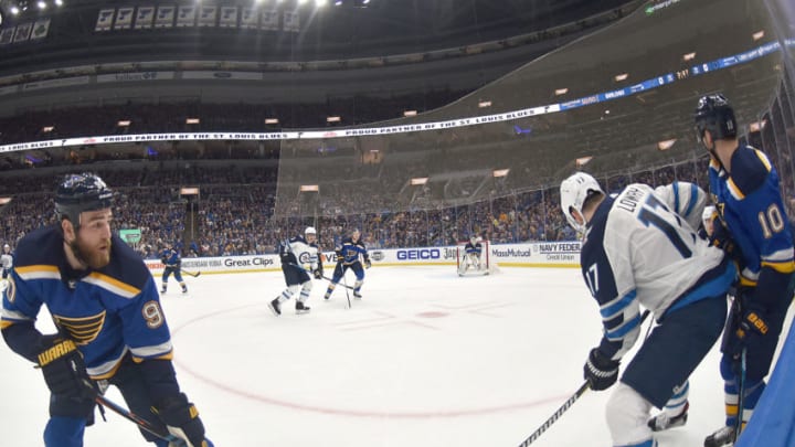 ST. LOUIS, MO - APRIL 16: St. Louis Blues center Ryan O'Reilly (90) and Winnipeg Jets center Adam Lowry (17) battle for a loose puck on the boards during a first round Stanley Cup Playoffs game between the Winnipeg Jets and the St. Louis Blues, on April 16, 2019, at Enterprise Center, St. Louis, Mo. (Photo by Keith Gillett/Icon Sportswire via Getty Images)