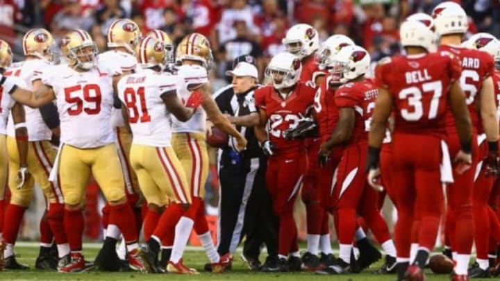 Dec 29, 2013; Phoenix, AZ, USA; NFL referee Walt Anderson breaks up a fight between San Francisco 49ers and Arizona Cardinals players at University of Phoenix Stadium. Mandatory Credit: Mark J. Rebilas-USA TODAY Sports