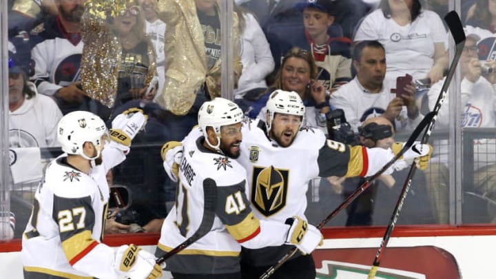 WINNIPEG, MB - MAY 14: Tomas Tatar #90 of the Vegas Golden Knights is congratulated by his teammates Shea Theodore #27 and Pierre-Edouard Bellemare #41 after scoring a first period goal against the Winnipeg Jets in Game Two of the Western Conference Finals during the 2018 NHL Stanley Cup Playoffs at Bell MTS Place on May 14, 2018 in Winnipeg, Canada. (Photo by Jason Halstead/Getty Images)