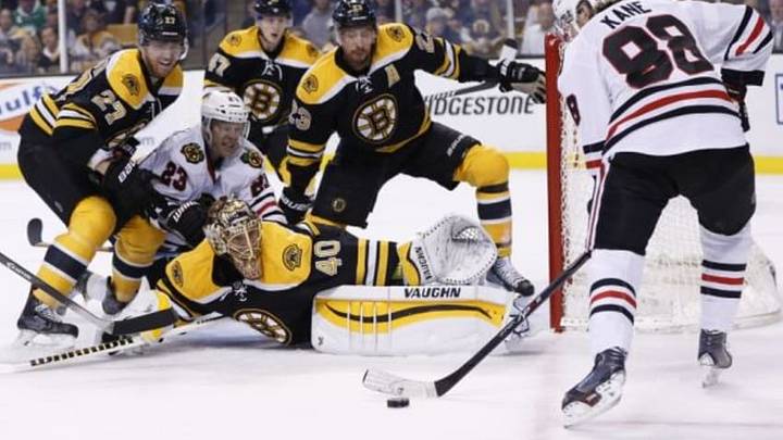 Dec 11, 2014; Boston, MA, USA; Chicago Blackhawks right wing Patrick Kane (88) takes a shot at Boston Bruins goalie Tuukka Rask (40) while right wing Kris Versteeg (23) is defended by defenseman Dougie Hamilton (27) during the second period at TD Banknorth Garden. Mandatory Credit: Greg M. Cooper-USA TODAY Sports