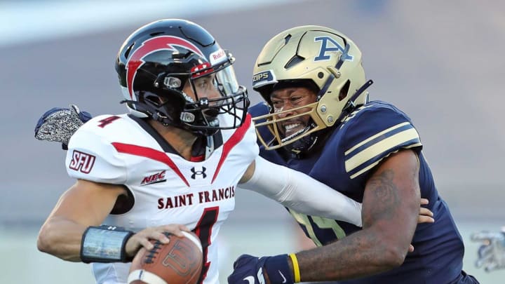 Akron Zips defensive lineman Victor Jones (44) attempts to wrap up St. Francis (Pa) Red Flash quarterback Cole Doyle (4) during the first half of an NCAA football game, Thursday, Sept. 1, 2022, in Akron, Ohio.Uazipsfb 5