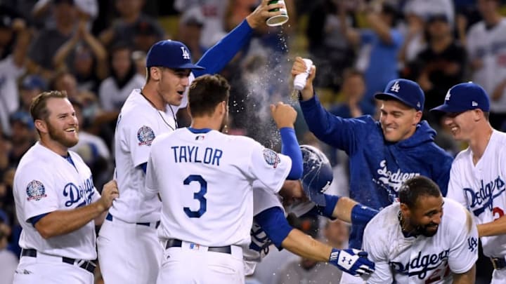 LOS ANGELES, CA - AUGUST 15: Brian Dozier #6 of the Los Angeles Dodger is showered by teammates, after his single scored Yasmani Grandal #9, to win 4-3 over the San Francisco Giants during the 12th inning at Dodger Stadium on August 15, 2018 in Los Angeles, California. (Photo by Harry How/Getty Images)