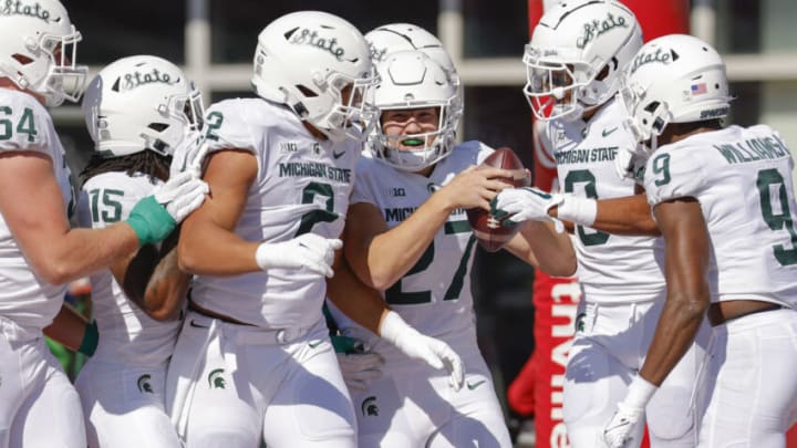 BLOOMINGTON, IN - OCTOBER 16: Members of the Michigan State Spartans defense celebrate with Cal Haladay #27 of the Michigan State Spartans after an interception returned for a touchdown against the Indiana Hoosiers at Indiana University on October 16, 2021 in Bloomington, Indiana. (Photo by Michael Hickey/Getty Images)