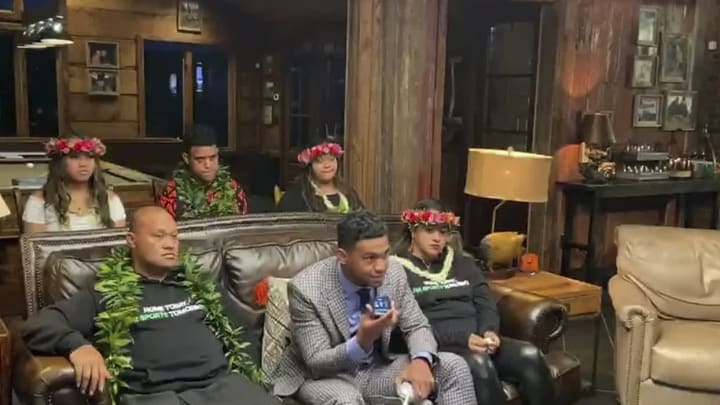 UNSPECIFIED LOCATION – APRIL 23: (EDITORIAL USE ONLY) In this still image from video provided by the NFL, Tua Tagovailoa, front center, holds up a phone during the first round of the 2020 NFL Draft on April 23, 2020. (Photo by NFL via Getty Images)