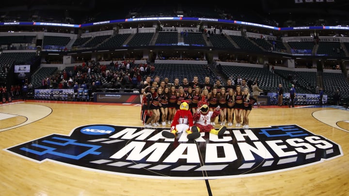 Mar 17, 2017; Indianapolis, IN, USA; The Louisville Cardinals mascot poses with the Jacksonville State Gamecocks spirit squad after their game in the first round of the 2017 NCAA Tournament at Bankers Life Fieldhouse. Mandatory Credit: Brian Spurlock-USA TODAY Sports