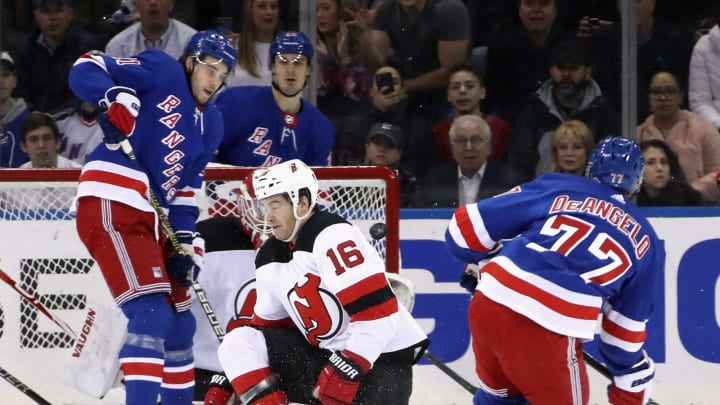 NEW YORK, NEW YORK – JANUARY 09: Tony DeAngelo #77 of the New York Rangers scores past Kevin Rooney #16 of the New Jersey Devils at 9:47 of the first period goal at Madison Square Garden on January 09, 2020 in New York City. (Photo by Bruce Bennett/Getty Images)