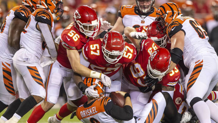 Kansas City Chiefs linebackers Ben Niemann (56) and Breeland Speaks (57) join defensive tackle Joey Ivie (93) in a tackle  (James Wooldridge/Kansas City Star/TNS via Getty Images)