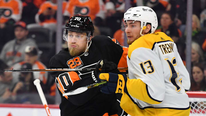 Mar 17, 2022; Philadelphia, Pennsylvania, USA; Philadelphia Flyers defenseman Rasmus Ristolainen (70) battles with Nashville Predators center Yakov Trenin (13) during the third period at Wells Fargo Center. Mandatory Credit: Eric Hartline-USA TODAY Sports