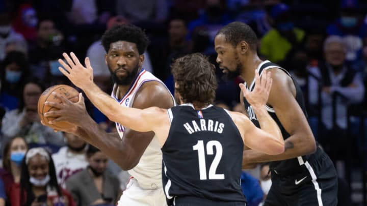 Philadelphia 76ers center Joel Embiid (left) controls the ball against Brooklyn Nets forward Joe Harris (12) and forward Kevin Durant (right) Mandatory Credit: Bill Streicher-USA TODAY Sports