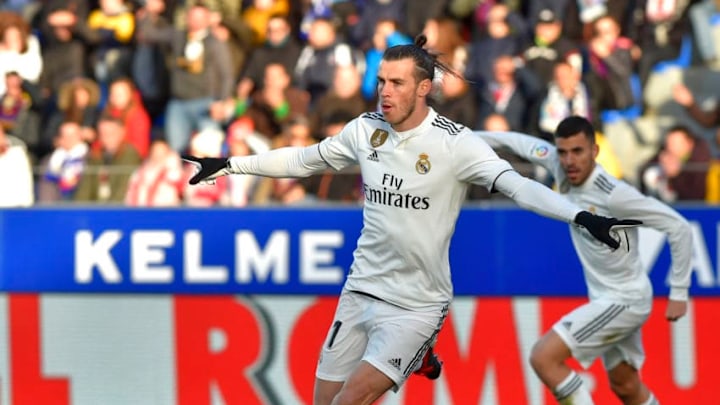 Real Madrid's Welsh forward Gareth Bale (C) celebrates after scoring his team's first goal during the Spanish league football match between SD Huesca and Real Madrid CF at the El Alcoraz stadium on December 9, 2018. (Photo by ANDER GILLENEA / AFP) (Photo credit should read ANDER GILLENEA/AFP/Getty Images)