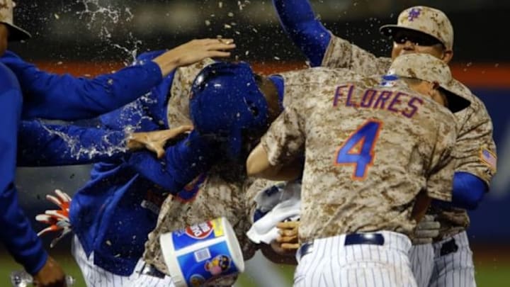May 18, 2015; New York City, NY, USA; New York Mets left fielder John Mayberry Jr. (44) is showered with water and sunflower seeds to celebrate the New York Mets 2-1 win over the St. Louis Cardinals after his game winning single in the 14th inning at Citi Field. Mandatory Credit: Noah K. Murray-USA TODAY Sports