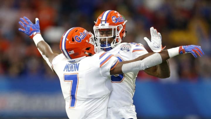 ATLANTA, GEORGIA - DECEMBER 29: Jeremiah Moon #7 and Chauncey Gardner-Johnson #23 of the Florida Gators celebrate a stopage on fourth down in the first quarter against the Michigan Wolverines during the Chick-fil-A Peach Bowl at Mercedes-Benz Stadium on December 29, 2018 in Atlanta, Georgia. (Photo by Mike Zarrilli/Getty Images)