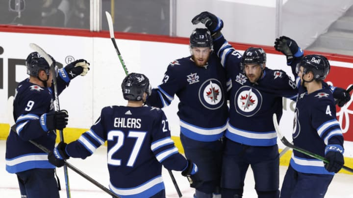 May 23, 2021; Winnipeg, Manitoba, CAN; Winnipeg Jets players celebrate the third period goal by left wing Mathieu Perreault (85) in game three of the first round of the 2021 Stanley Cup Playoffs at Bell MTS Place. Mandatory Credit: James Carey Lauder-USA TODAY Sports
