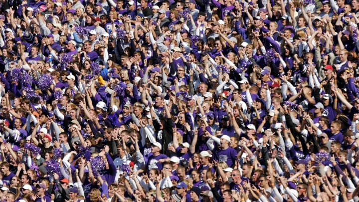 MANHATTAN, KS – OCTOBER 16: Kansas State Wildcats fans cheer their team as they take a lead on an interception against the Oklahoma Sooners in the third quarter on October 16, 2004 at KSU Stadium in Manhattan, Kansas. The Sooners won 31-21. (Photo by Brian Bahr/Getty Images)