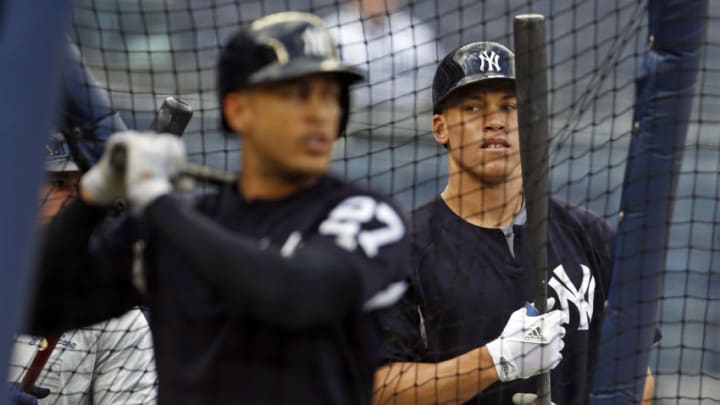 NEW YORK, NY - APRIL 6: Aaron Judge #99 of the New York Yankees watches Giancarlo Stanton #27 of the New York Yankees during batting practice prior to their game against the Baltimore Orioles at Yankee Stadium on April 6, 2018 in the Bronx borough of New York City. (Photo by Adam Hunger/Getty Images)